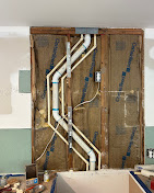 PVC drain and vent rough-in in wall framing with PEX supply lines